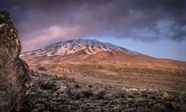 the summit of mountain Kilimanjaro covered with fogs and ice